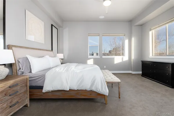 a bedroom with a bed and a large window
