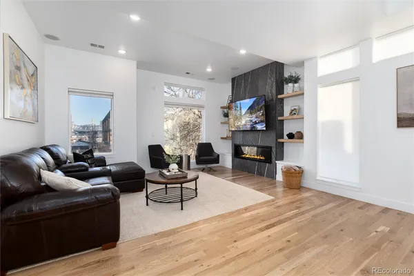 a living room with furniture and a fireplace