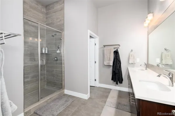 a bathroom with a double vanity sink a and a mirror