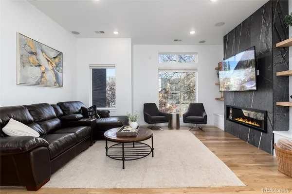 a living room with fireplace furniture and a flat screen tv