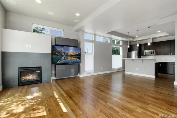 a view of kitchen with stainless steel appliances granite countertop cabinets and wooden floor