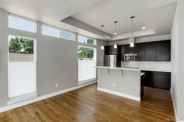 a kitchen with stainless steel appliances a microwave a stove and refrigerator