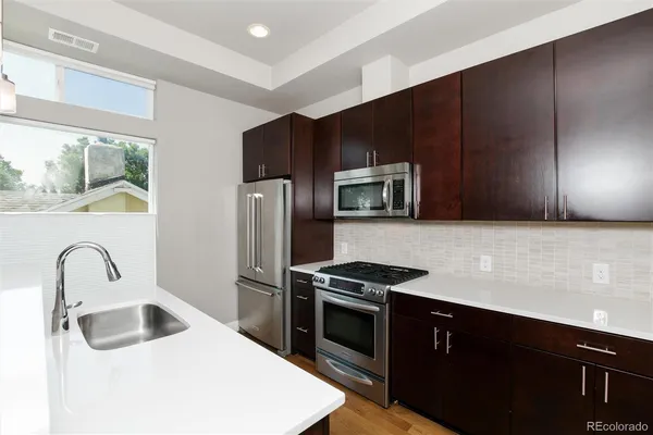 a kitchen with a sink and a window