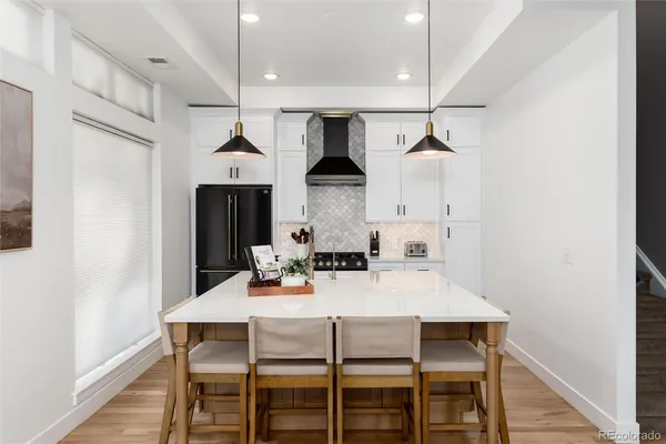 a dining room with furniture and wooden floor