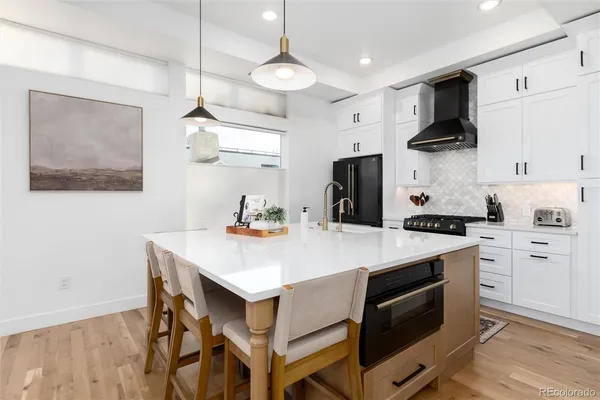 a kitchen with a stove a refrigerator and a sink