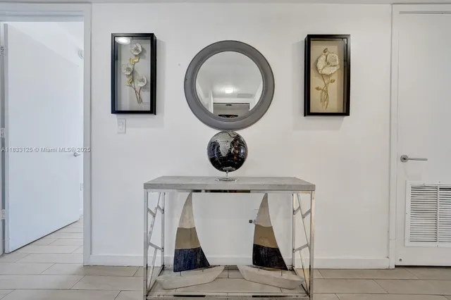 a view of entryway with a table and a lamp