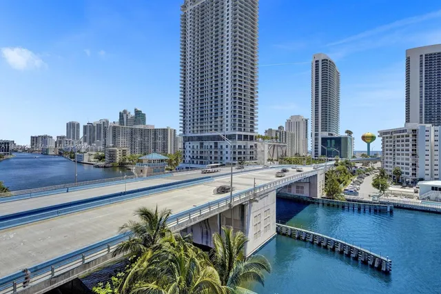 a view of swimming pool with outdoor seating and city view
