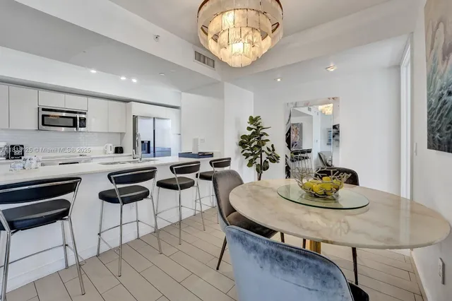 a kitchen with a table and chairs in it
