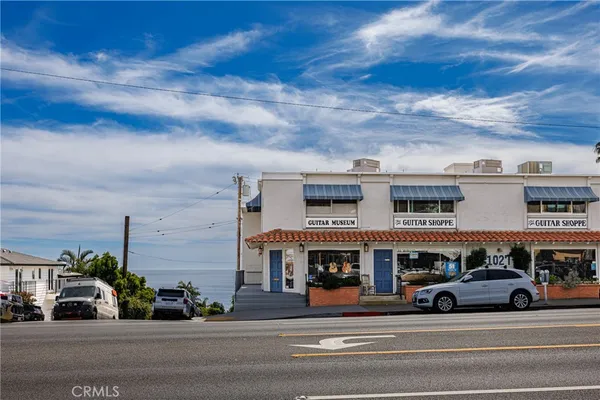 a view of building with car parked