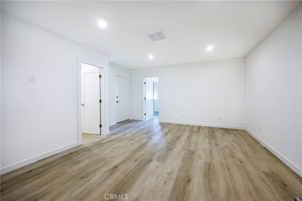 an empty room with wooden floor