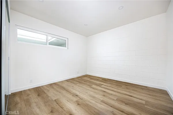 a view of a room with wooden floor