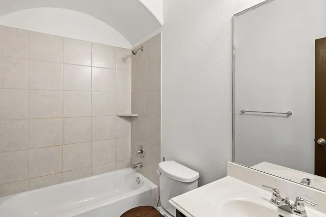 a bathroom with a bathtub and toilet