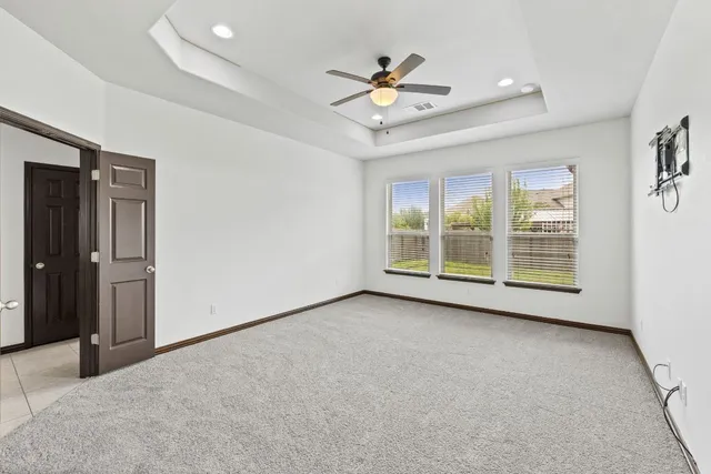 a view of a livingroom with a ceiling fan and window