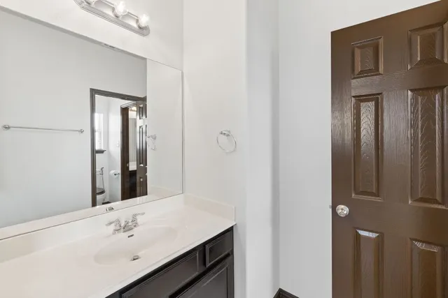 a bathroom with a sink vanity and a mirror