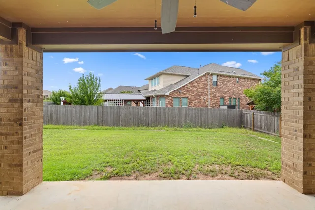 a view of a backyard with a small cabin and a chair