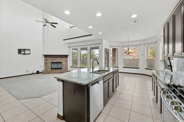 a kitchen with granite countertop a stove and a sink