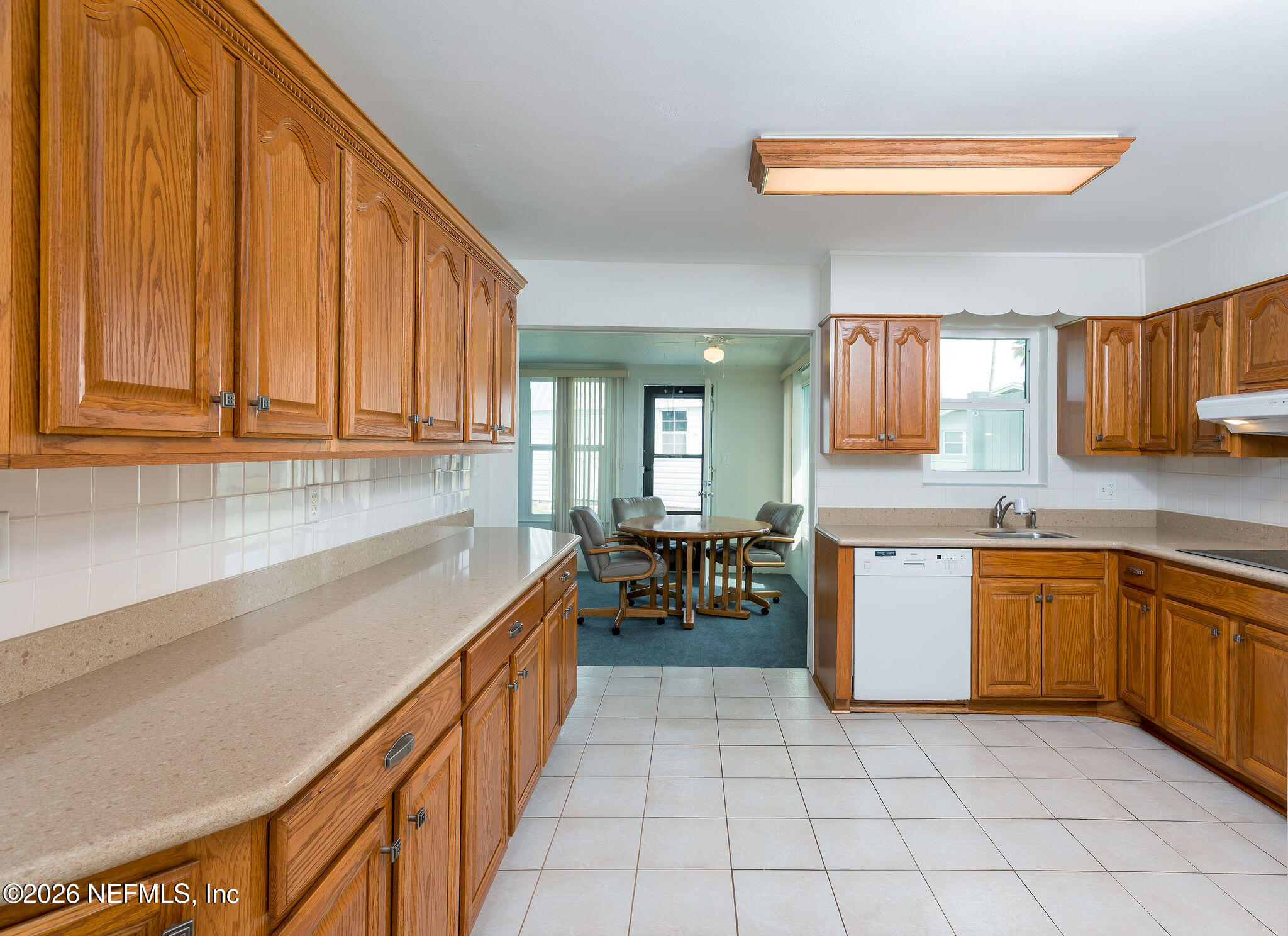 37 Berkley Road Ormond Beach, FL 32176 - Photo 13 of 33 a kitchen with granite countertop a sink cabinets and stove top oven