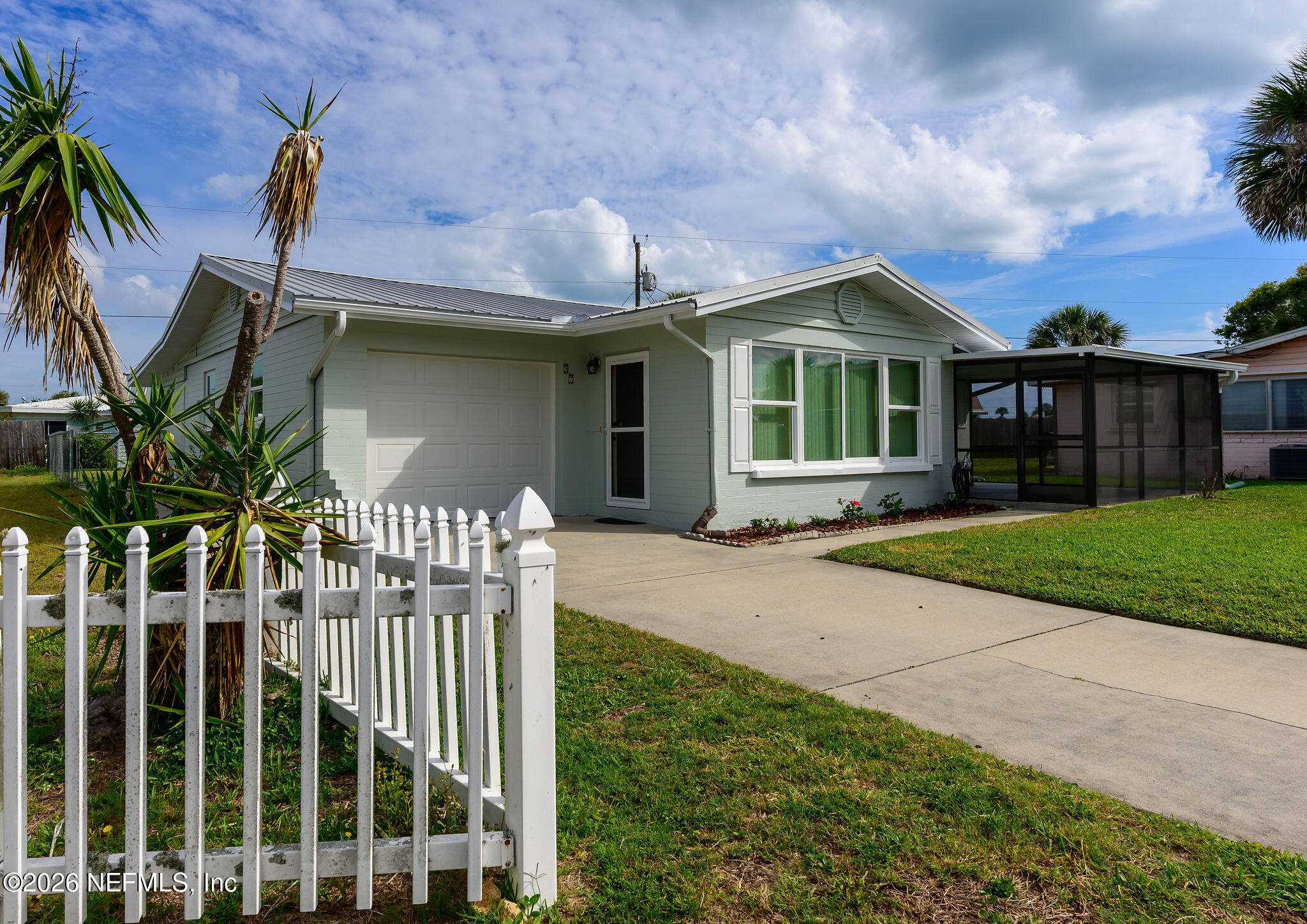 37 Berkley Road Ormond Beach, FL 32176 - Photo 2 of 33 a front view of a house with a garden and plants