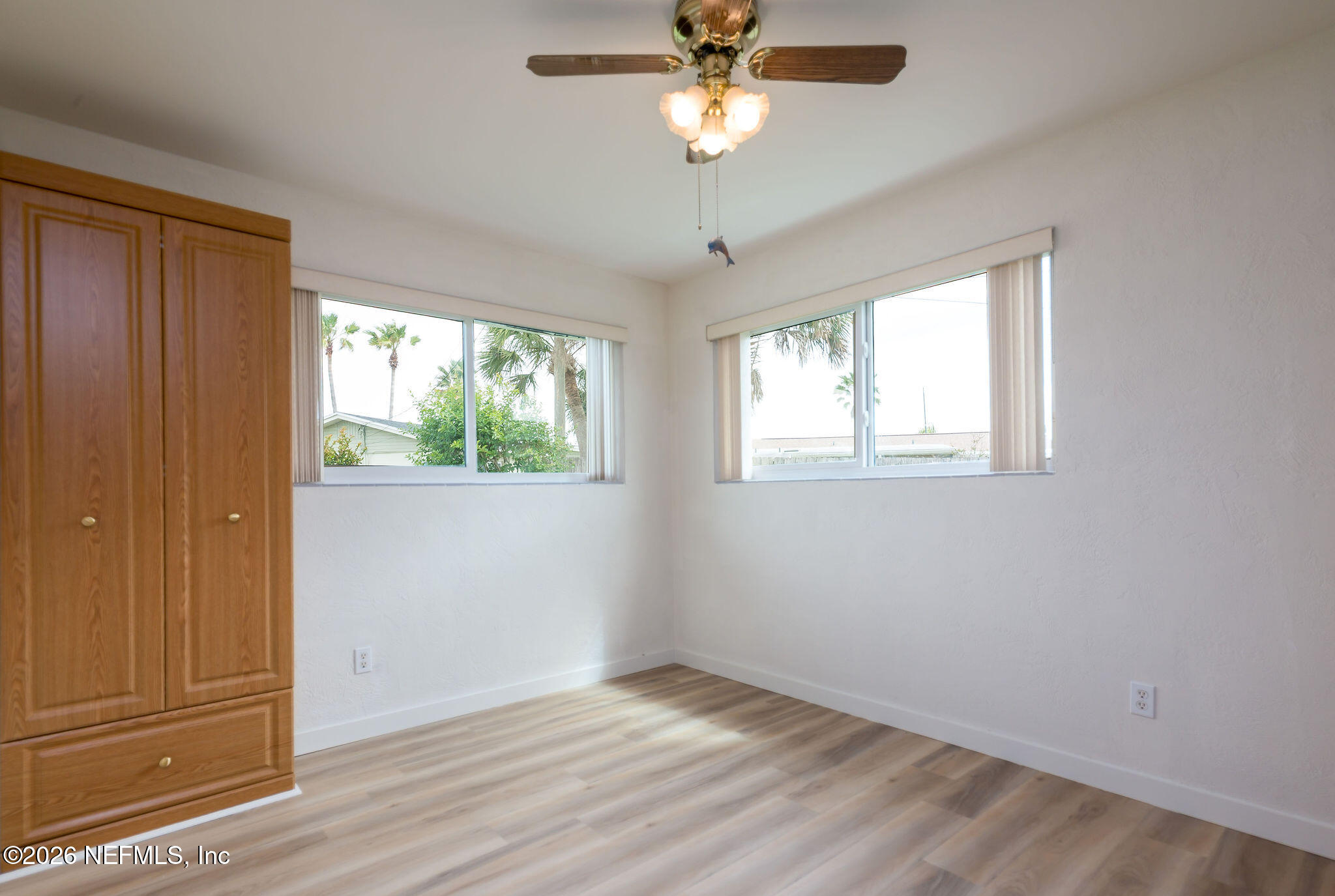 37 Berkley Road Ormond Beach, FL 32176 - Photo 23 of 33 a view of an empty room with wooden floor and window