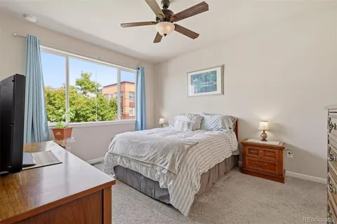 a bedroom with a bed window and a flat screen tv