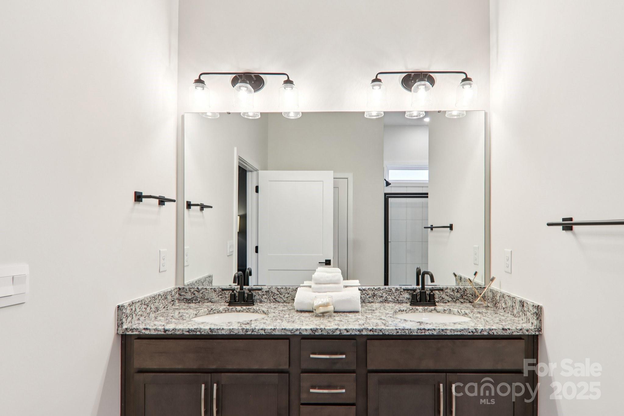 623 River Btm Road Fletcher, NC 28732 - Photo 23 of 48 a bathroom with a granite countertop sink and a mirror