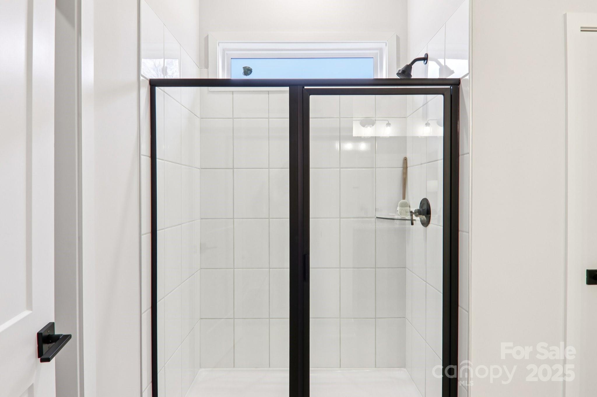 623 River Btm Road Fletcher, NC 28732 - Photo 24 of 48 a bathroom with a glass shower door