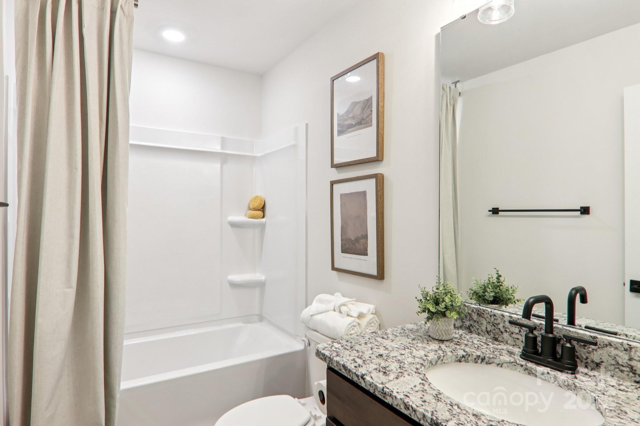 623 River Btm Road Fletcher, NC 28732 - Photo 37 of 48 a bathroom with a granite countertop sink tub and a mirror