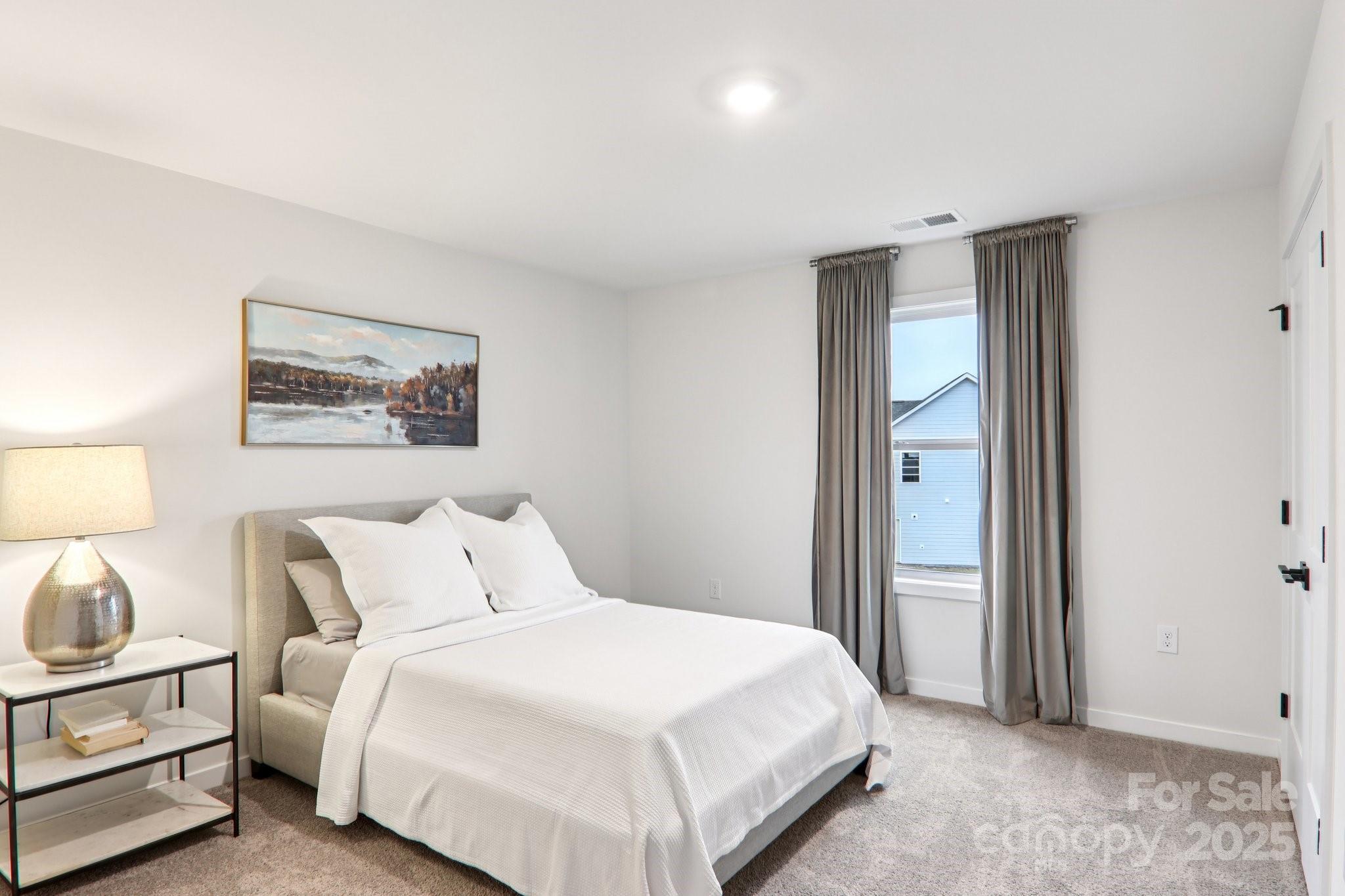 623 River Btm Road Fletcher, NC 28732 - Photo 38 of 48 a bedroom with a bed and a lamp on dresser