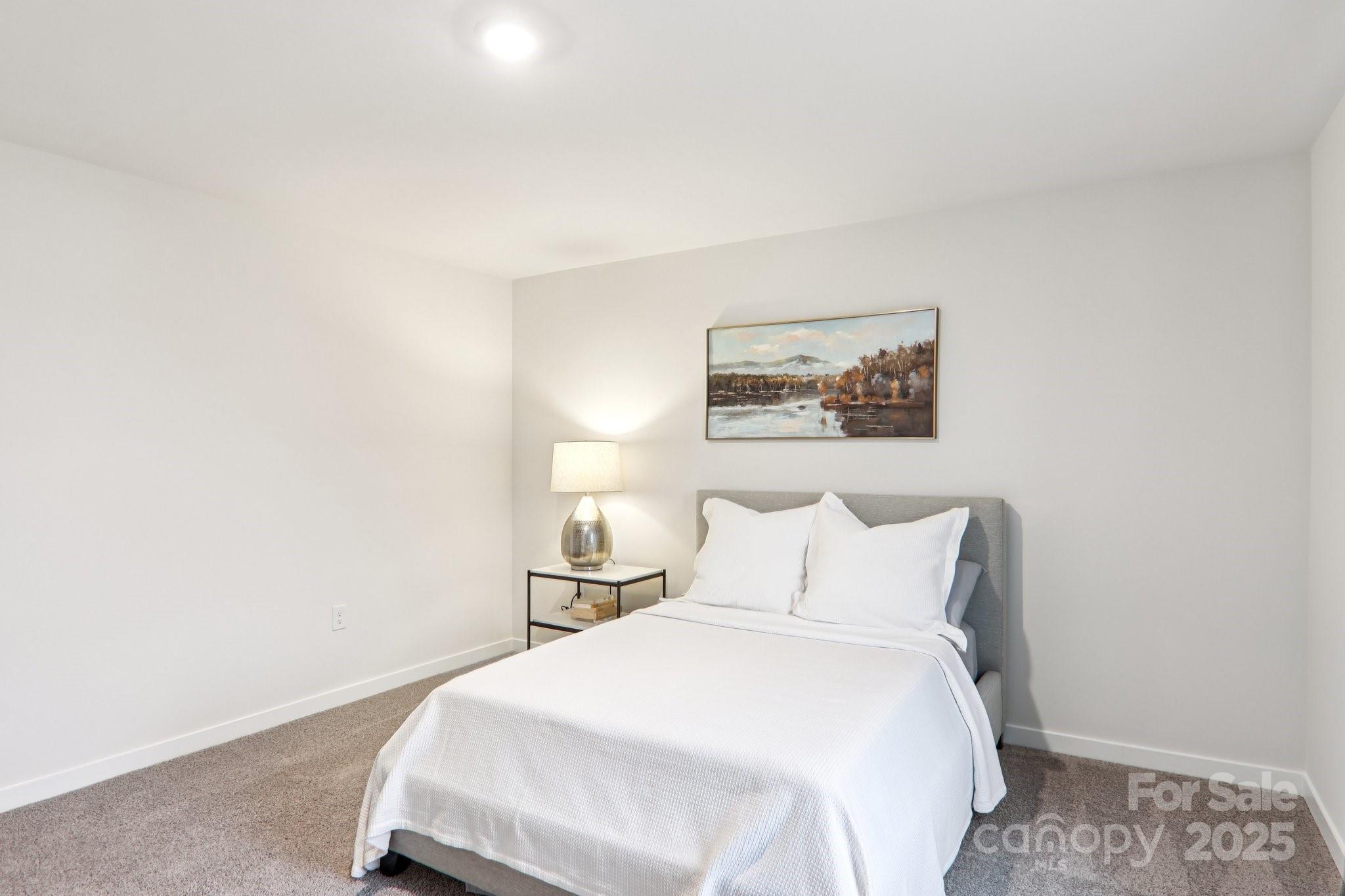 623 River Btm Road Fletcher, NC 28732 - Photo 39 of 48 a bedroom with a bed and a wall painting