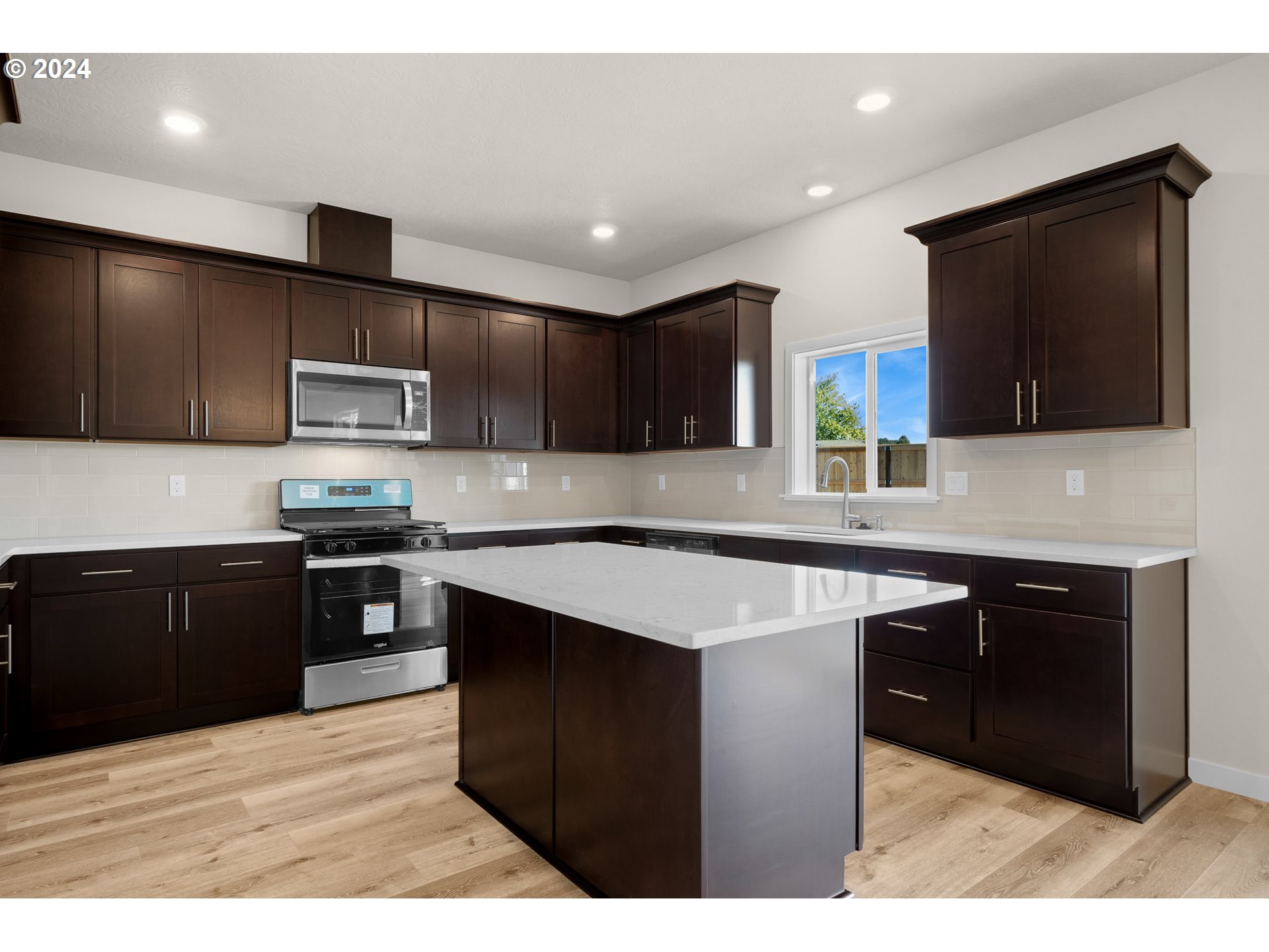 4361 Chaparal Place Albany, OR 97321 - Photo 2 of 36 a kitchen with stainless steel appliances kitchen island granite countertop a sink stove and microwave
