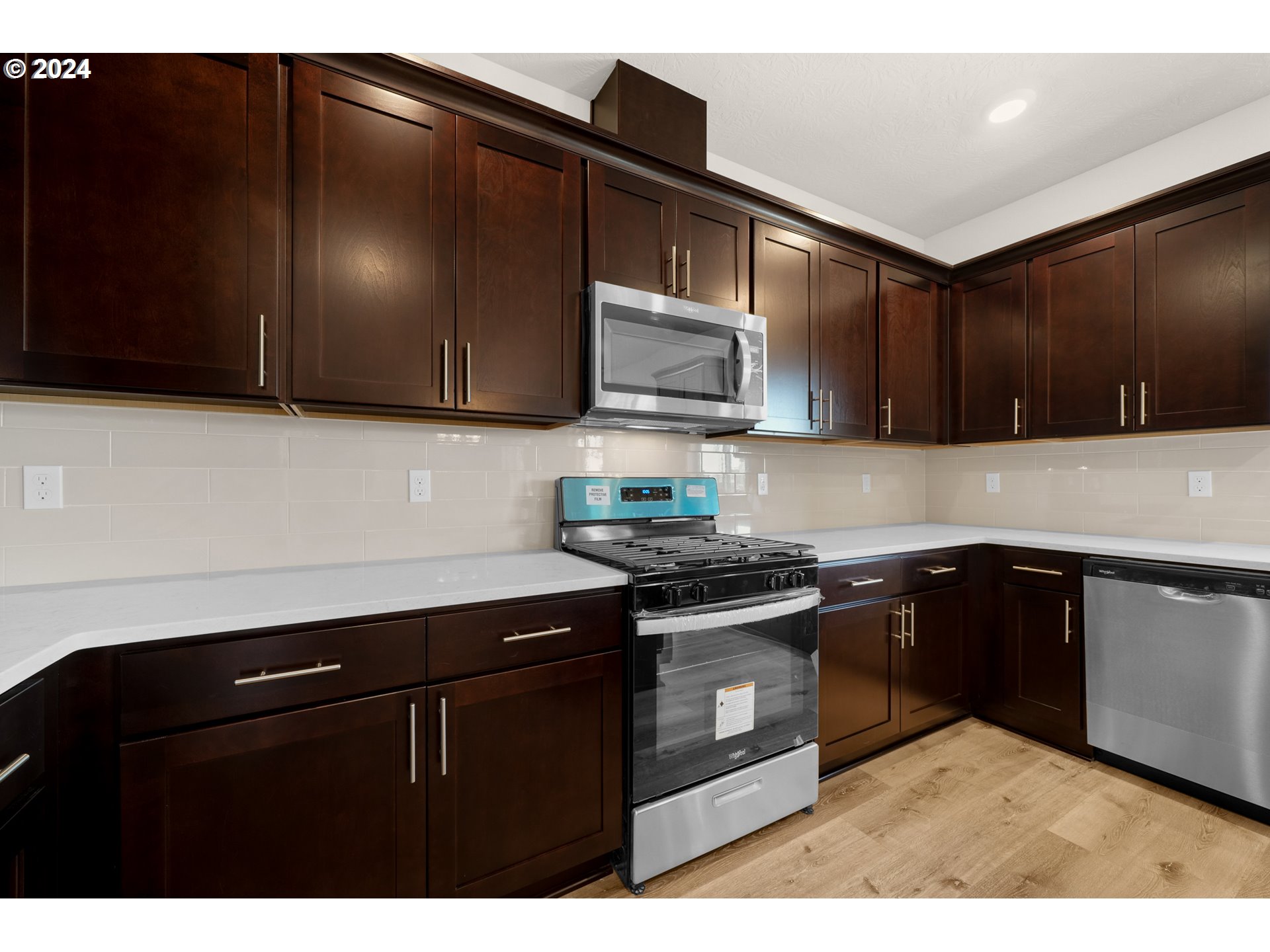 4361 Chaparal Place Albany, OR 97321 - Photo 3 of 36 a kitchen with black cabinets and black appliances