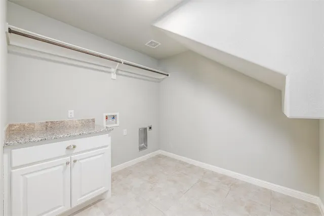 a bathroom with a granite countertop sink and white cabinets