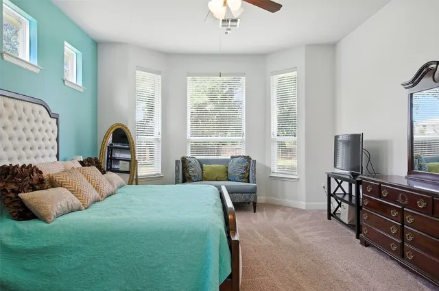 a bedroom with a bed and a couch