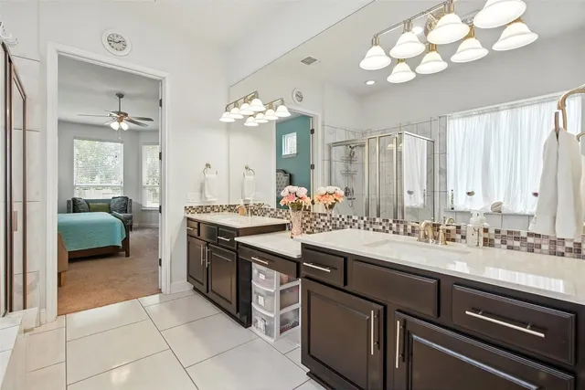 a bathroom with a sink double vanity and a mirror
