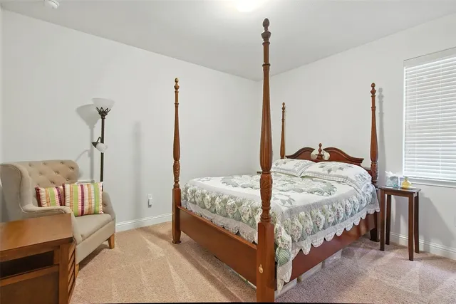 a bedroom with a bed and a night stand