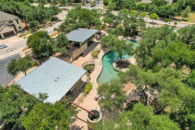 an aerial view of a house with a yard and sitting area
