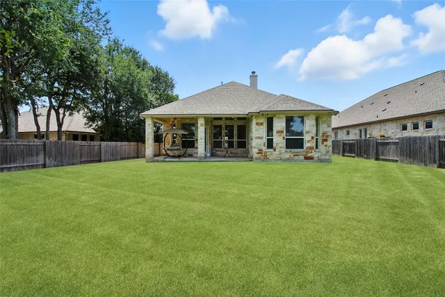 a view of a house with a yard and sitting area