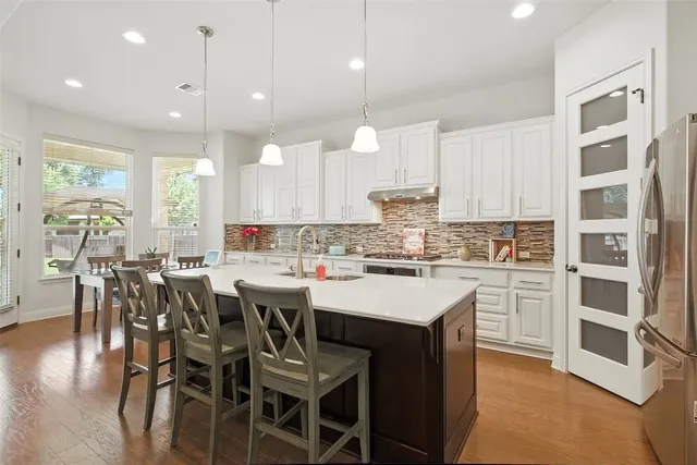 a kitchen with a center island appliances and cabinets