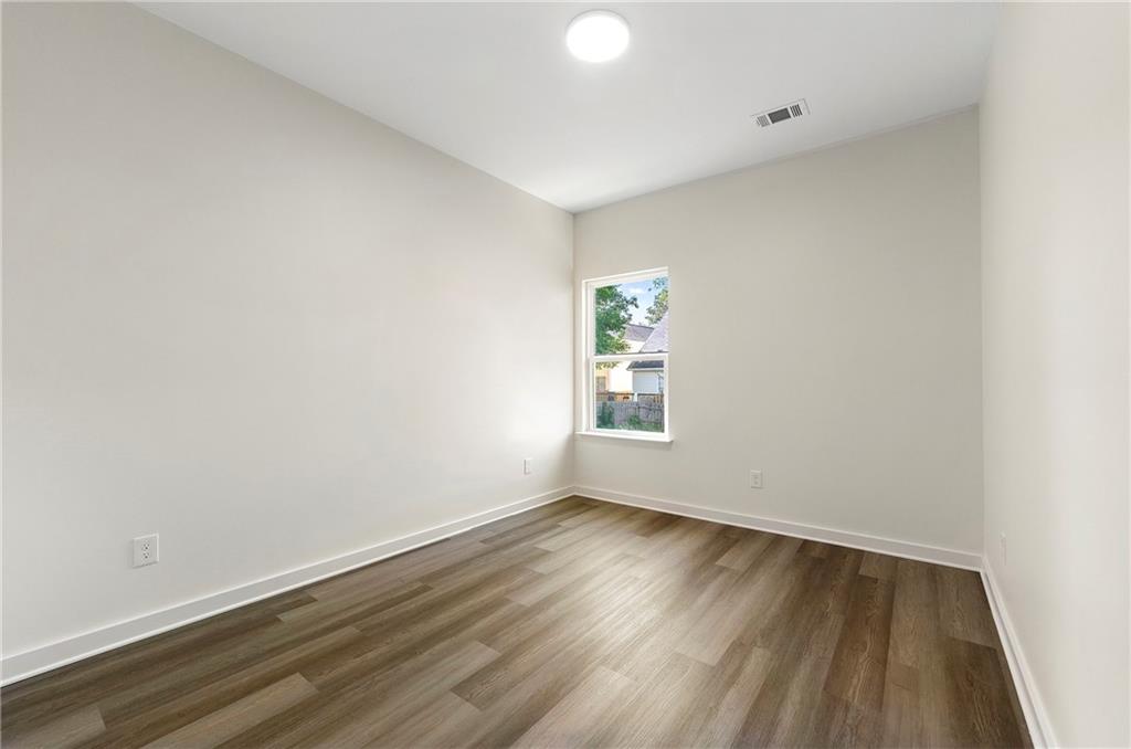 3607 Brycewood Drive Decatur, GA 30034 - Photo 8 of 15 an empty room with wooden floor and windows