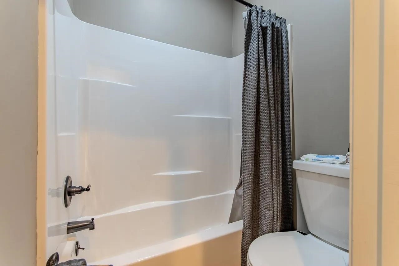 2134 Otis Plunk Road Bethel Springs, TN 38315 - Photo 21 of 35 a bathroom with a toilet and a bathtub
