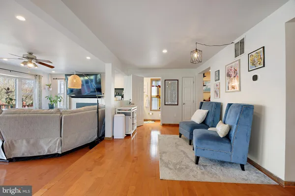 a living room with furniture fireplace and a large window