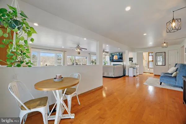 a living room with furniture a wooden floor and a chandelier