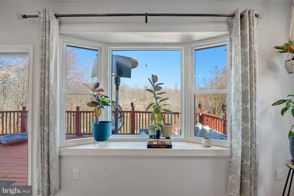 a spacious bedroom with a large bed a rug and painting on the wall
