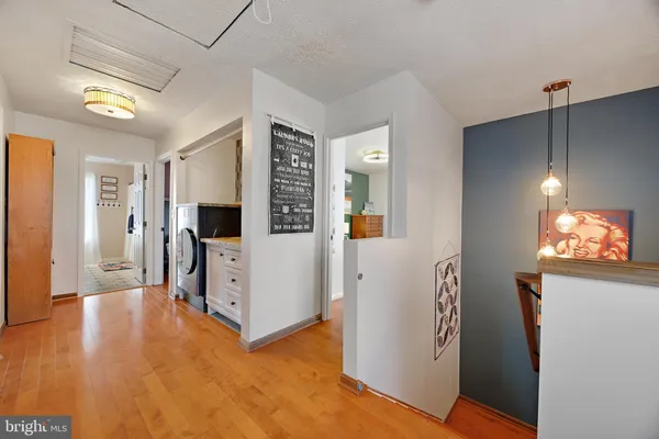 a living room with furniture stairs and a chandelier