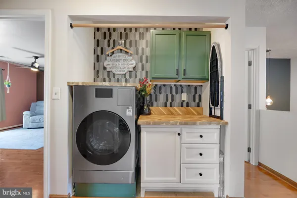 a kitchen with granite countertop wooden cabinets and white appliances