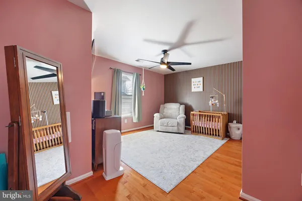 a bathroom with a toilet sink vanity and mirror