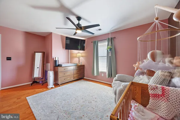 a view of a workspace with furniture and a flat screen tv
