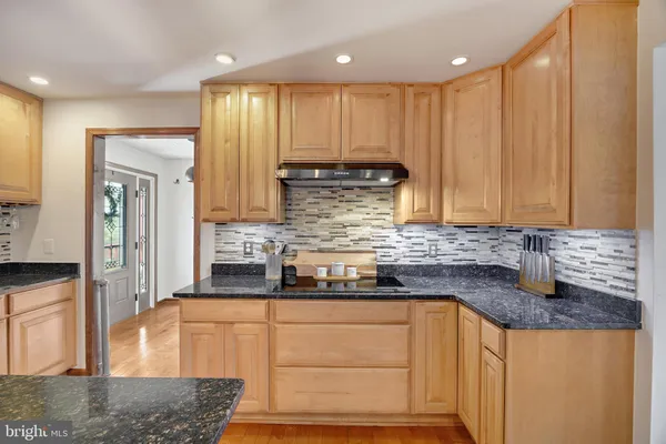 a kitchen with stainless steel appliances granite countertop a stove a sink and a granite counter tops