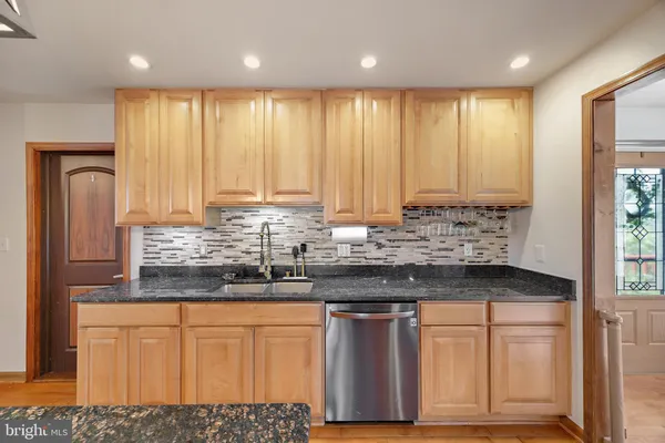 a kitchen with stainless steel appliances granite countertop a refrigerator sink and cabinets