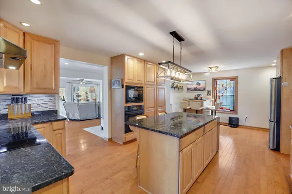 a kitchen with granite countertop cabinets and refrigerator